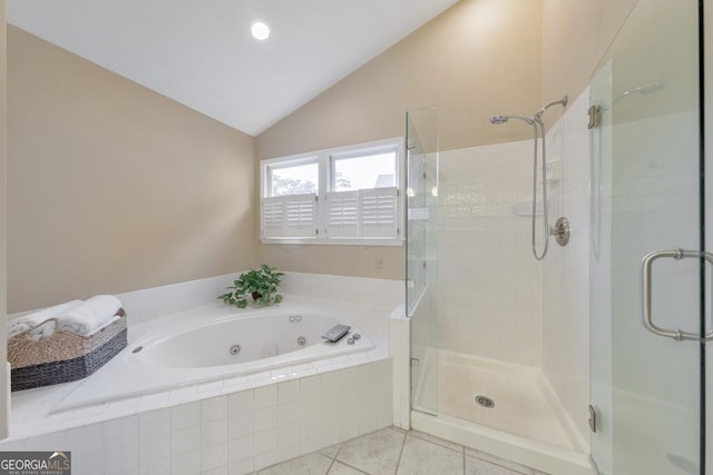 bathroom featuring a shower stall, a whirlpool tub, tile patterned floors, and vaulted ceiling