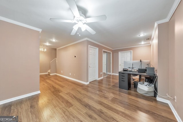 office area featuring wood finished floors, ornamental molding, baseboards, ceiling fan, and a chandelier