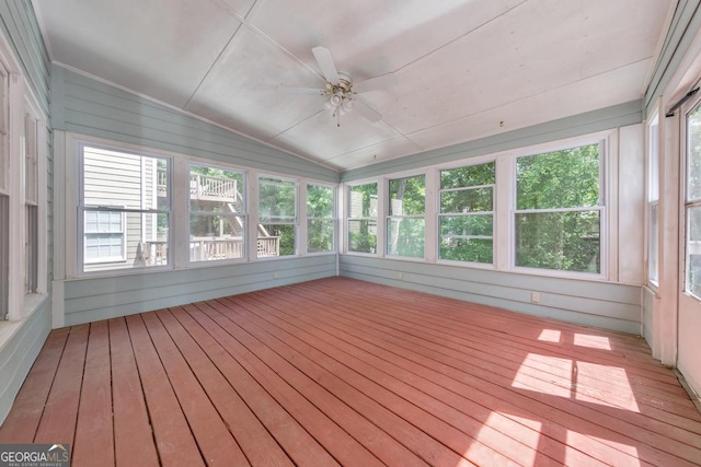 unfurnished sunroom featuring a ceiling fan, plenty of natural light, and lofted ceiling