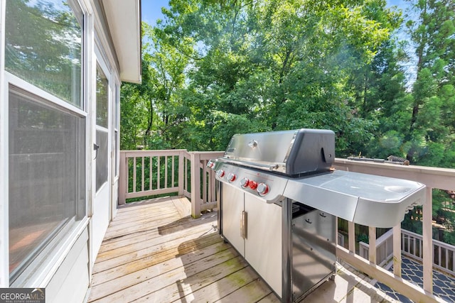 wooden deck with a grill