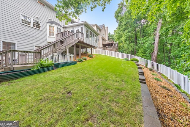 view of yard with a deck and stairs