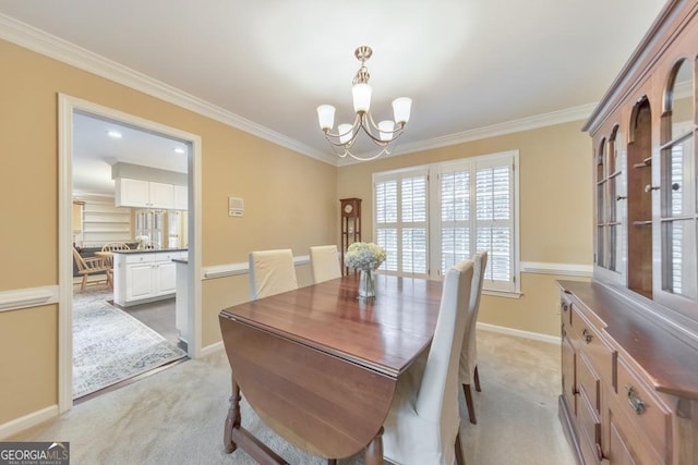 dining room with a chandelier, light carpet, ornamental molding, baseboards, and healthy amount of natural light