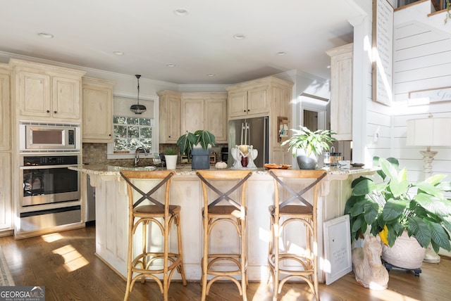 505 River Ridge Rd, Clarkesville, GA 30523 - kitchen with cream cabinets, light stone countertops, a warming drawer, appliances with stainless steel finishes, and tasteful backsplash