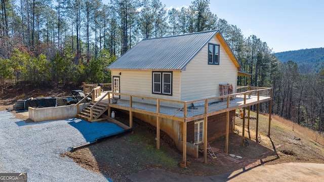 164 Delilah Ln, Lakemont, GA 30552 - back of property featuring a deck, a forest view, and metal roof