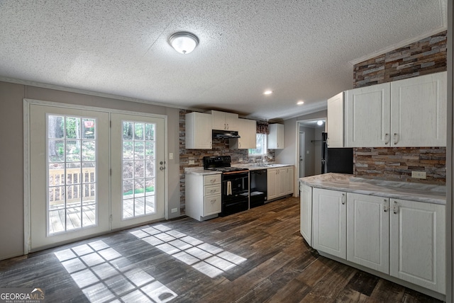kitchen with a textured ceiling, white cabinets, black appliances, light countertops, and tasteful backsplash