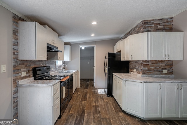 kitchen featuring crown molding, a textured ceiling, black appliances, and a sink
