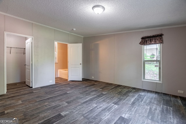 unfurnished bedroom with ornamental molding, a textured ceiling, and dark wood-style floors