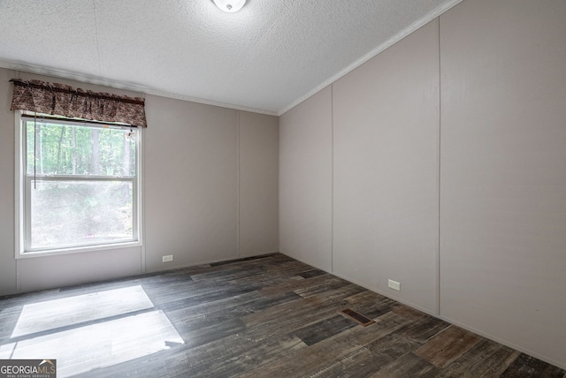 unfurnished room with a textured ceiling and wood finished floors