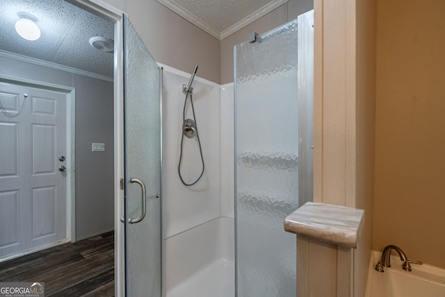 bathroom featuring a stall shower, ornamental molding, and wood finished floors
