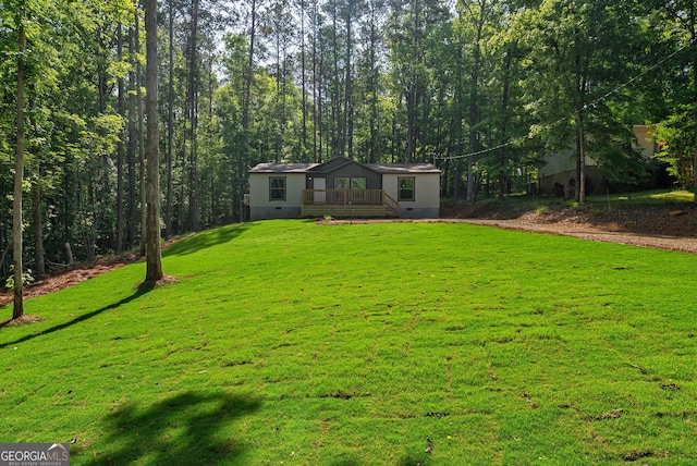 manufactured / mobile home featuring crawl space, a wooden deck, and a front yard