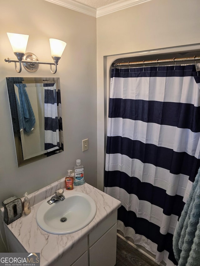 full bath with crown molding, a shower with shower curtain, and vanity
