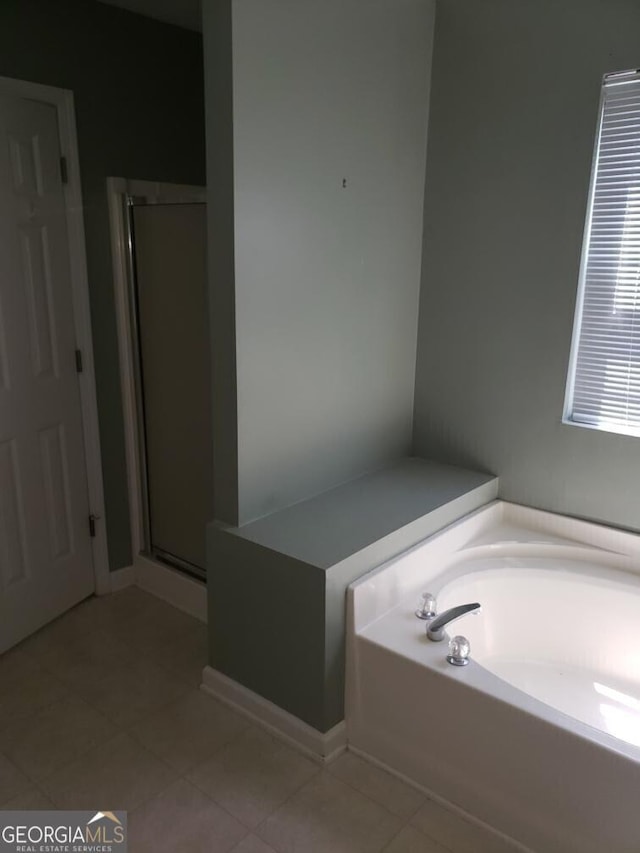 2075 Tussahaw Xing, Mcdonough, GA 30252 - full bath featuring tile patterned floors, a bath, and a stall shower