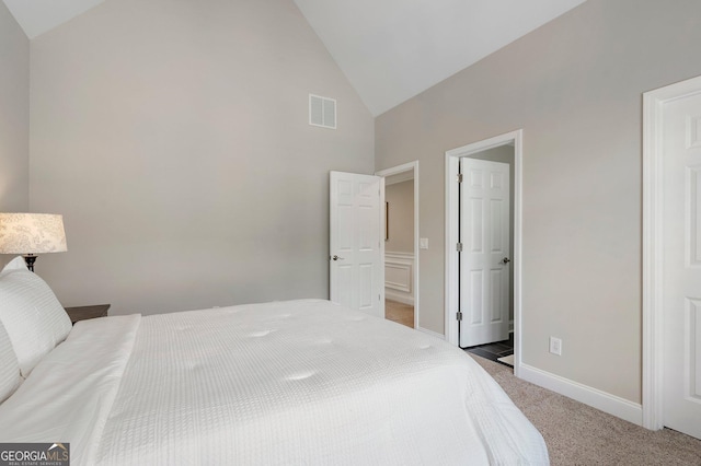 bedroom with carpet, high vaulted ceiling, and baseboards