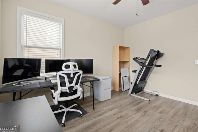 office area featuring light wood-style floors, baseboards, and a ceiling fan