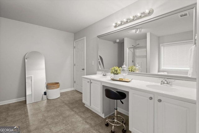 bathroom featuring a sink, double vanity, a shower, and visible vents