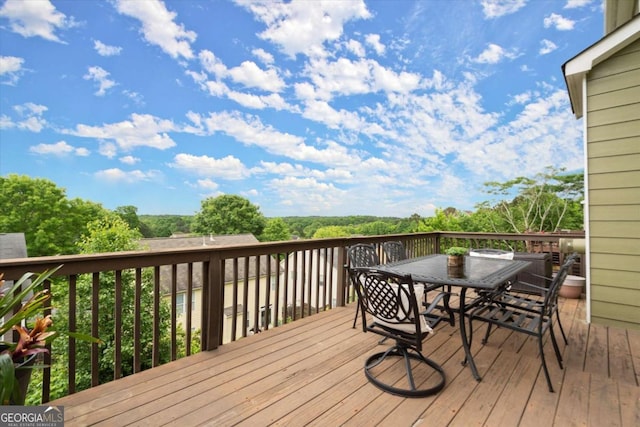 wooden terrace featuring outdoor dining area