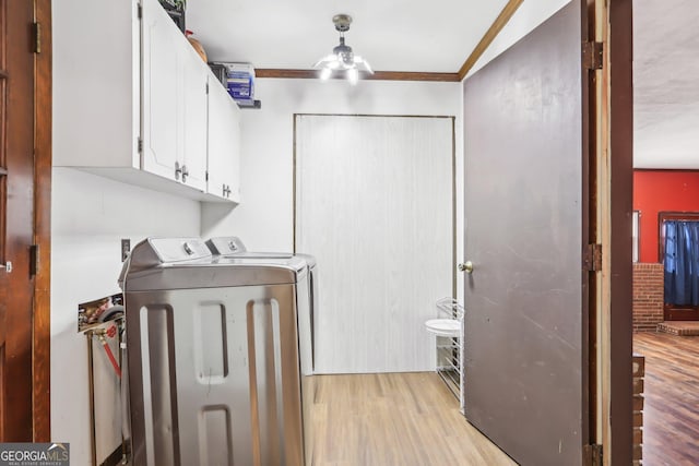 1240 C M Copelan Rd, Madison, GA 30650 - laundry room with cabinet space, independent washer and dryer, light wood-style flooring, a ceiling fan, and crown molding