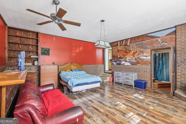 1240 C M Copelan Rd, Madison, GA 30650 - bedroom featuring wood finished floors and brick wall