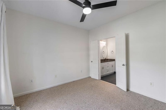 821 Ralph Mcgill Blvd NE Unit 2113, Atlanta, GA 30306 - unfurnished bedroom with a sink, ensuite bathroom, baseboards, ceiling fan, and dark colored carpet