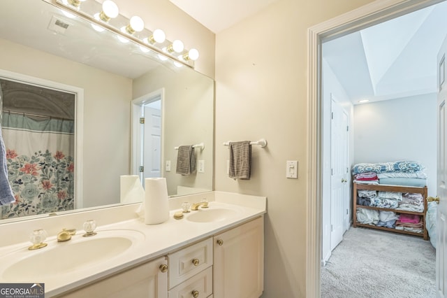 full bath featuring double vanity, ensuite bath, visible vents, and a sink