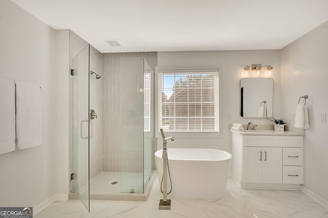 bathroom with marble look tile flooring, a stall shower, a freestanding bath, and vanity