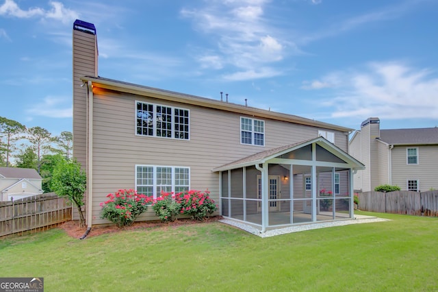 back of property featuring a sunroom and a chimney