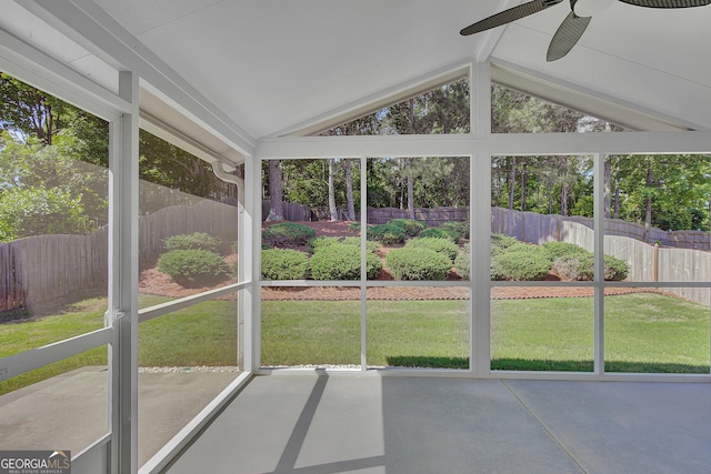unfurnished sunroom featuring ceiling fan, lofted ceiling, and healthy amount of natural light