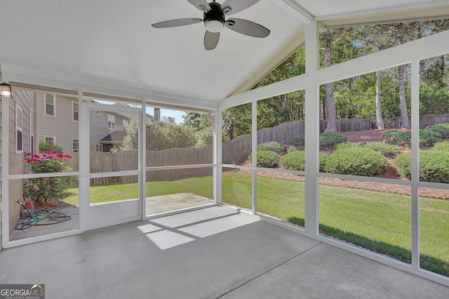 unfurnished sunroom with vaulted ceiling and a ceiling fan