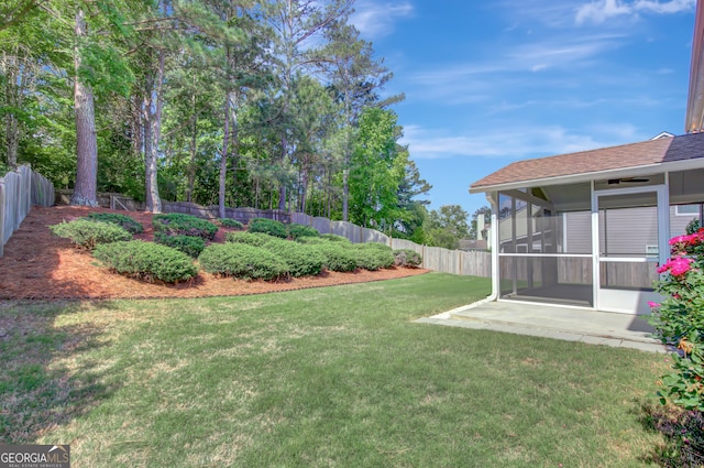 view of yard with a sunroom and a patio