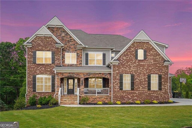 6375 Haystack Ct, Cumming, GA 30040 - view of front of property with covered porch, a lawn, and brick siding
