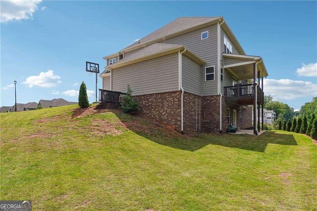 6375 Haystack Ct, Cumming, GA 30040 - view of property exterior featuring brick siding, a lawn, and a balcony