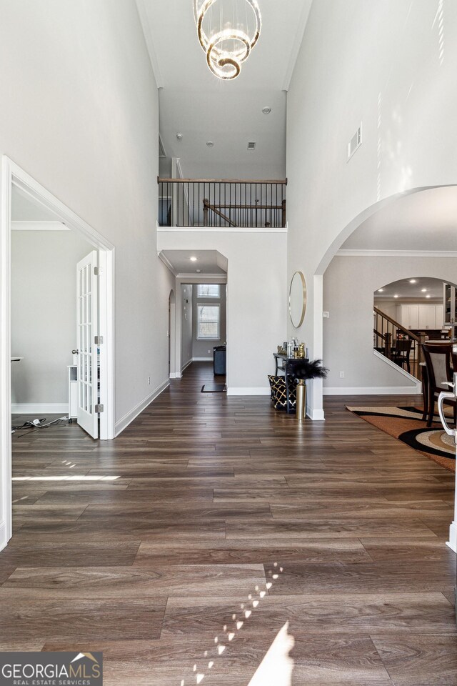 6375 Haystack Ct, Cumming, GA 30040 - entryway with wood finished floors, arched walkways, stairs, ornamental molding, and baseboards