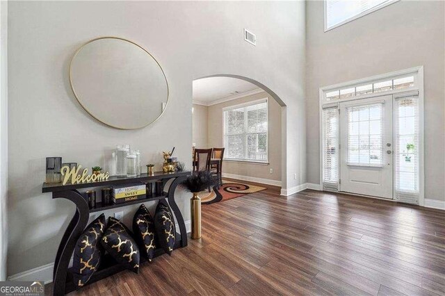 6375 Haystack Ct, Cumming, GA 30040 - entryway with visible vents, wood finished floors, baseboards, and arched walkways