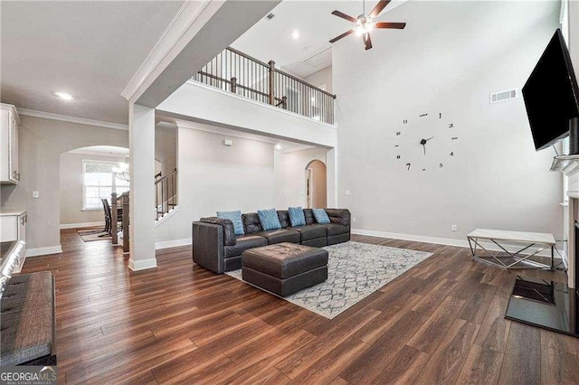 6375 Haystack Ct, Cumming, GA 30040 - living area featuring wood finished floors, a ceiling fan, baseboards, arched walkways, and ornamental molding
