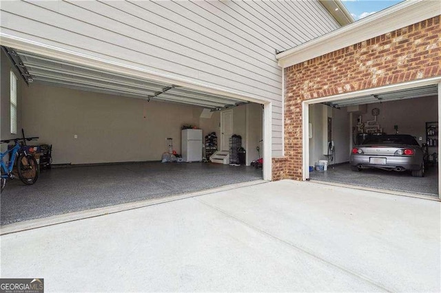 6375 Haystack Ct, Cumming, GA 30040 - garage with concrete driveway and freestanding refrigerator