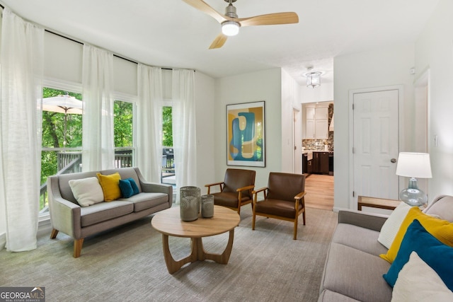 living area with a ceiling fan