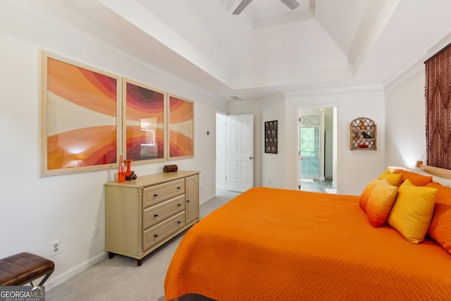bedroom with light colored carpet, a raised ceiling, connected bathroom, and baseboards