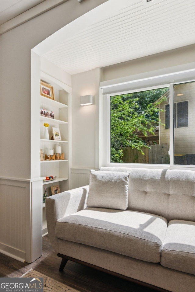sitting room featuring wainscoting and wood finished floors