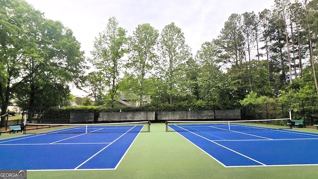 view of tennis court with fence and community basketball court