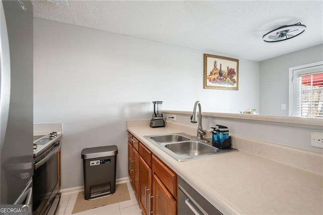 6918 Gallant Cir SE Unit 22, Mableton, GA 30126 - kitchen featuring a sink, stainless steel appliances, a textured ceiling, and brown cabinets