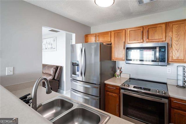 6918 Gallant Cir SE Unit 22, Mableton, GA 30126 - kitchen with light countertops, appliances with stainless steel finishes, brown cabinets, and a sink
