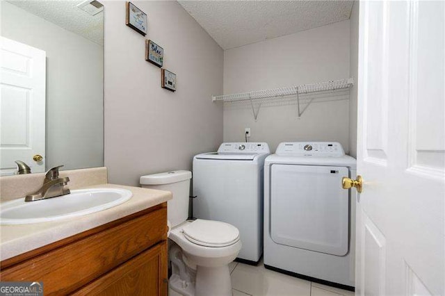 6918 Gallant Cir SE Unit 22, Mableton, GA 30126 - bathroom with washing machine and dryer, toilet, visible vents, and a textured ceiling