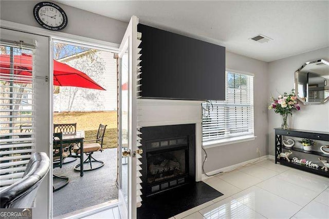6918 Gallant Cir SE Unit 22, Mableton, GA 30126 - living area featuring light tile patterned floors, visible vents, baseboards, and a fireplace with flush hearth