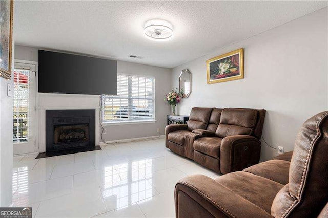 6918 Gallant Cir SE Unit 22, Mableton, GA 30126 - tiled living room with a textured ceiling, baseboards, a fireplace with flush hearth, and visible vents