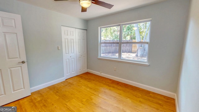 165 Cherokee Cir, Hinesville, GA 31313 - unfurnished bedroom with light wood-style floors, a closet, baseboards, and a ceiling fan