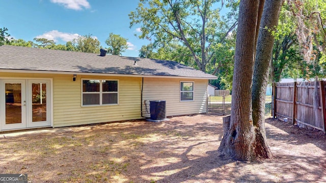 165 Cherokee Cir, Hinesville, GA 31313 - rear view of property with fence, cooling unit, french doors, and roof with shingles