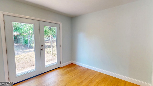 165 Cherokee Cir, Hinesville, GA 31313 - doorway with french doors, light wood-style floors, and baseboards