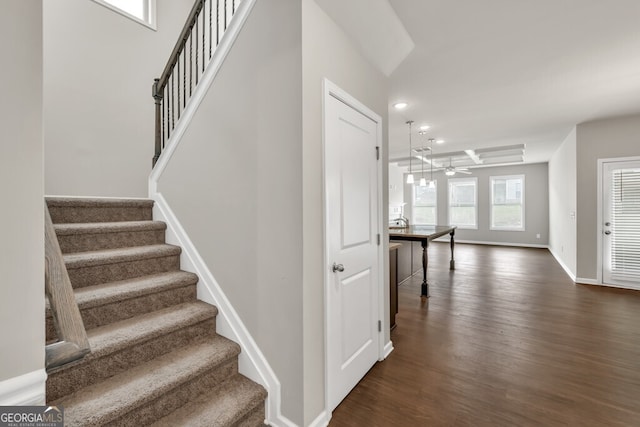 stairs with wood finished floors, recessed lighting, baseboards, and ceiling fan