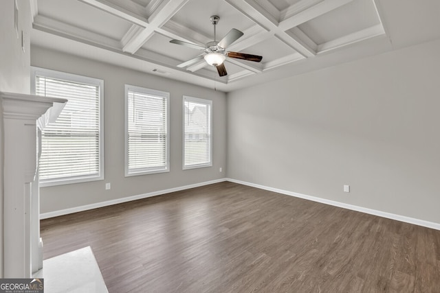 spare room featuring coffered ceiling, ceiling fan, wood finished floors, baseboards, and beam ceiling