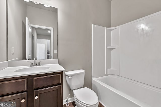 full bathroom featuring toilet, vanity, baseboards, and shower / tub combination
